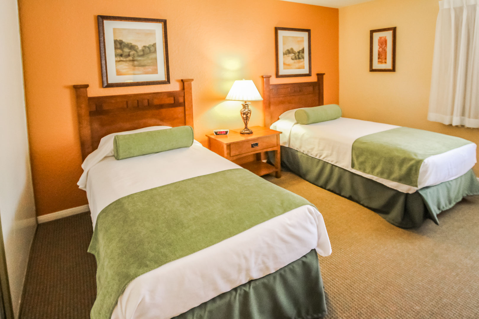 A cozy bedroom with double beds at VRI's Lake Arrowhead Chalets in California.